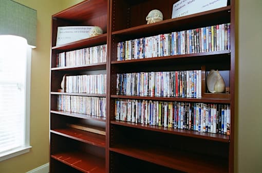 A bookshelf filled with books and DVDs.