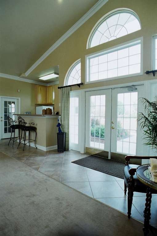 A dining room with a table and chairs.