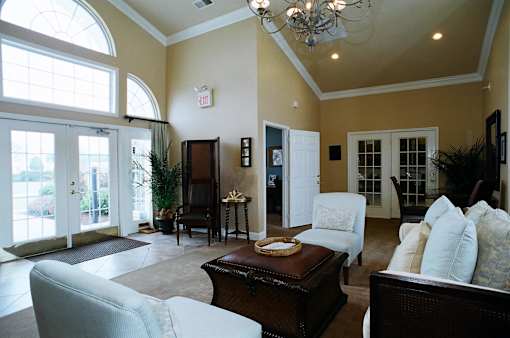 A living room with a couch, chair, and coffee table.