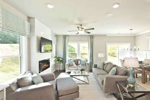 A living room with a fireplace and a television.