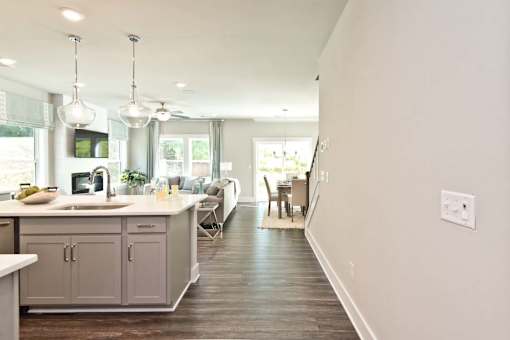 A modern kitchen with a long counter and a sink.