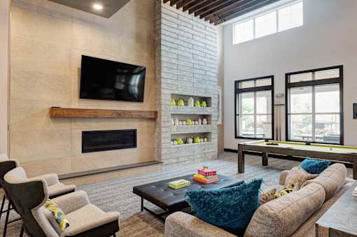 A modern living room with a fireplace and a television.