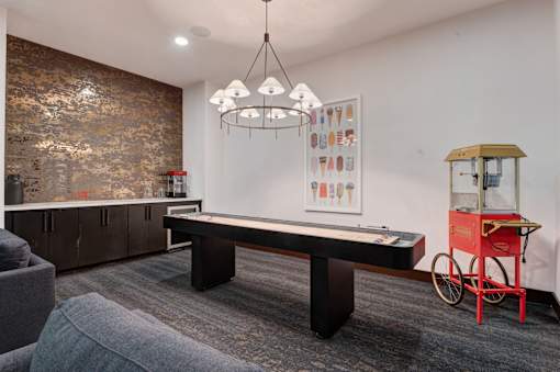 A room with a pool table and a red bicycle.