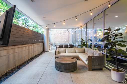 A modern living room with a flat screen TV mounted on the wall.