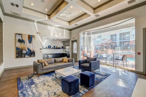 a living room with a couch and a table in front of a large window