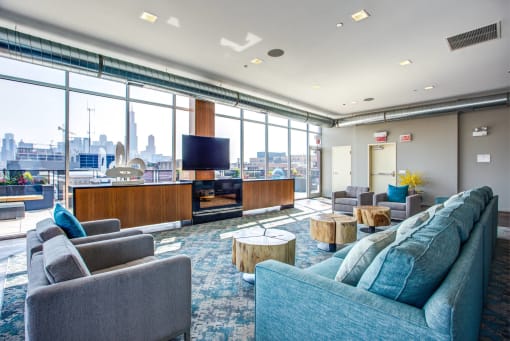 a living room with couches and chairs and a television