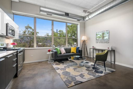 a living room with a large window and a couch and a table
