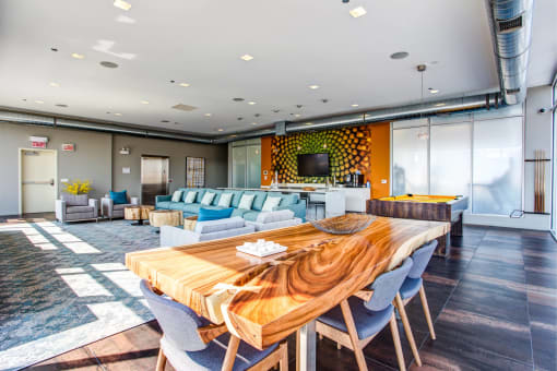 a living room and dining room with a wooden table