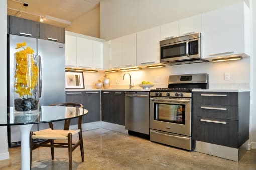 a kitchen with stainless steel appliances and a glass table