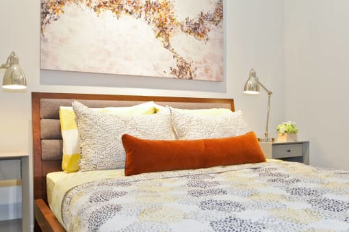 a bedroom with a bed and a painting on the wall