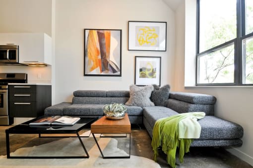 a living room with a gray couch and a coffee table