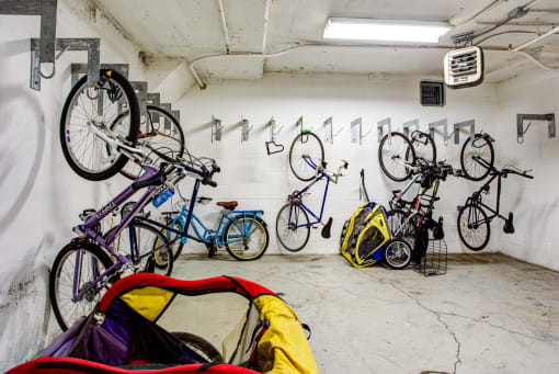 a group of bikes hanging on a wall in a garage