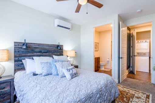 a bedroom with a bed and a ceiling fan
