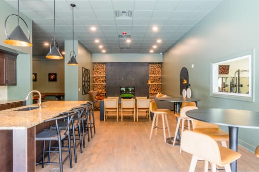 a dining room with tables and chairs and a bar with chairs