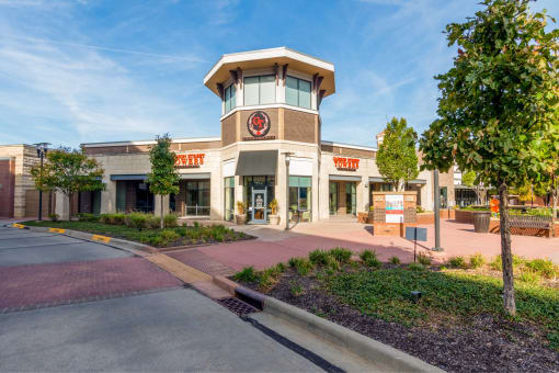 the exterior of a store with a clock on the front of it