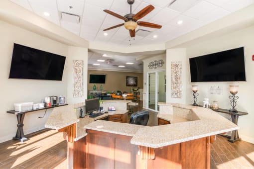 a kitchen with a counter top and a tv