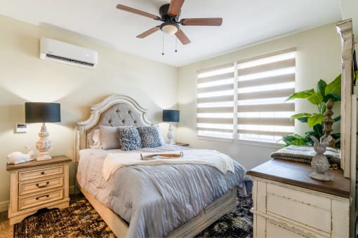 a bedroom with a bed and a ceiling fan