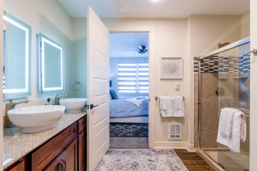 a bathroom with a shower and a sink and a mirror