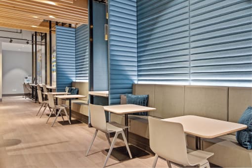 the seats in the lobby of the building are made of wood and metal