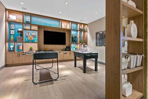 a room with a desk and a television in it