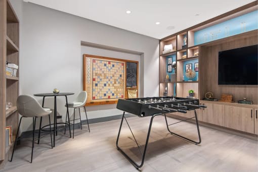 a game room with a foosball table and a television