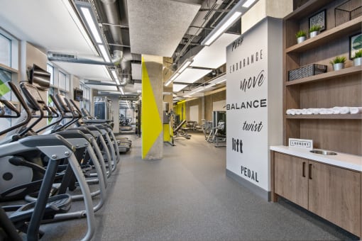 a room filled with cardio equipment and chairs in a gym