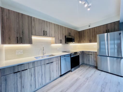 a kitchen with wooden cabinets and stainless steel appliances