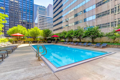 a swimming pool in the middle of a city skyscraper