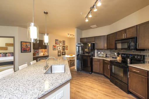 Luxurious Kitchen with Large Island, Pendant Lighting and Designer Tile Backsplash | Nashville Tennessee Apartments for Rent | 909 Flats