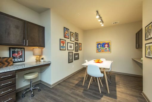 a dining room with a white table and chairs
