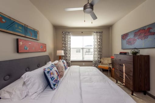 a bedroom with a large bed and a ceiling fan