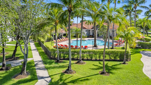 a house with a swimming pool and palm trees