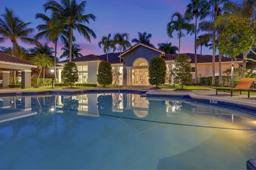 Night shot of the pool area and lighted clubhouse.