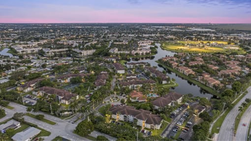 an aerial view of a city with a river and houses
