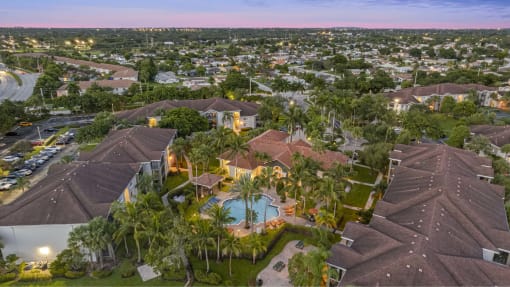 a birds eye view of a house with a pool and palm trees