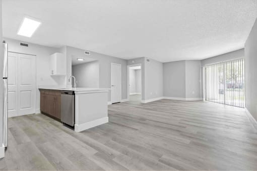 Open floor plans with wood like flooring.