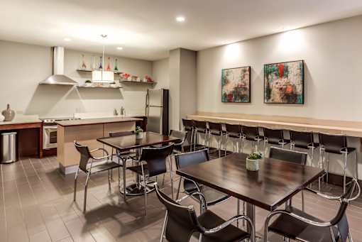 A modern kitchen with a dining table and chairs.