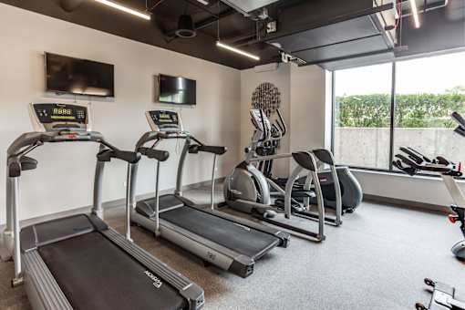 A gym with treadmills and exercise bikes.