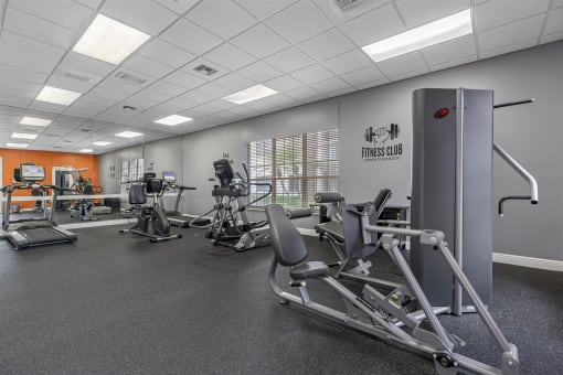 a gym with exercise equipment and weights in a building