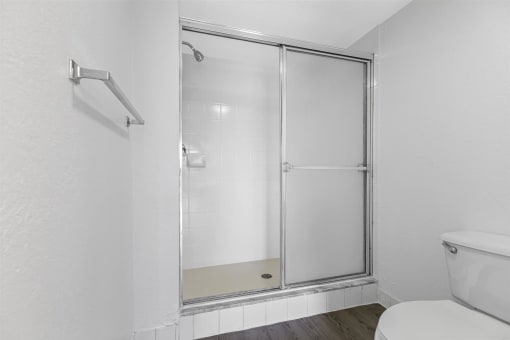 an empty bathroom with a shower and a toilet