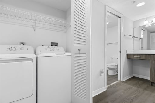 Open concept floor plans with large windows, vinyl wood flooring throughout, stainless steel kitchens, upgraded lighting with white and wood accents