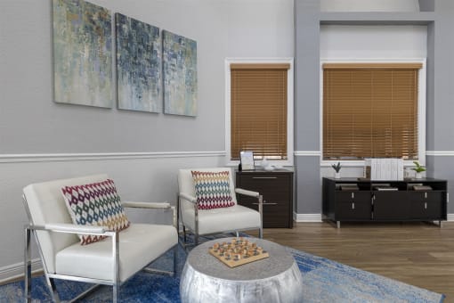 a living room with two chairs and a table with a chess board