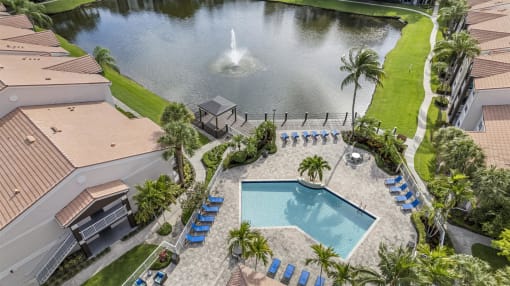 a backyard with a pool and a pond with a fountain