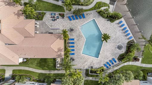 Beautiful drone shot overview of pool, clubhouse and lake area