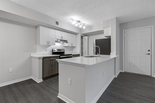 a white kitchen with a large counter top and