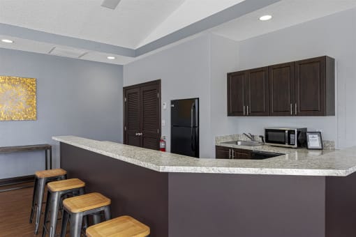 a kitchen with a counter top and a bar with stools