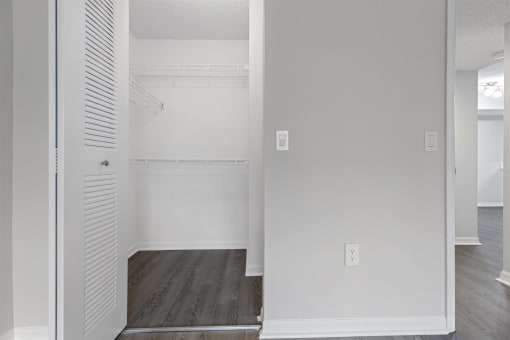 an empty closet in a room with white walls and wood floors