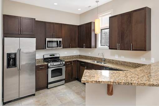 A kitchen with granite countertops and stainless steel appliances.