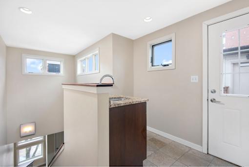 A room with a brown cabinet and a window.