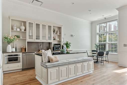 A kitchen with a large island and a dining area.